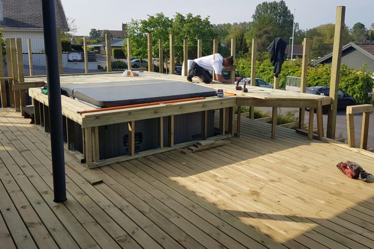 Construction process building in a spa in a wooden deck.